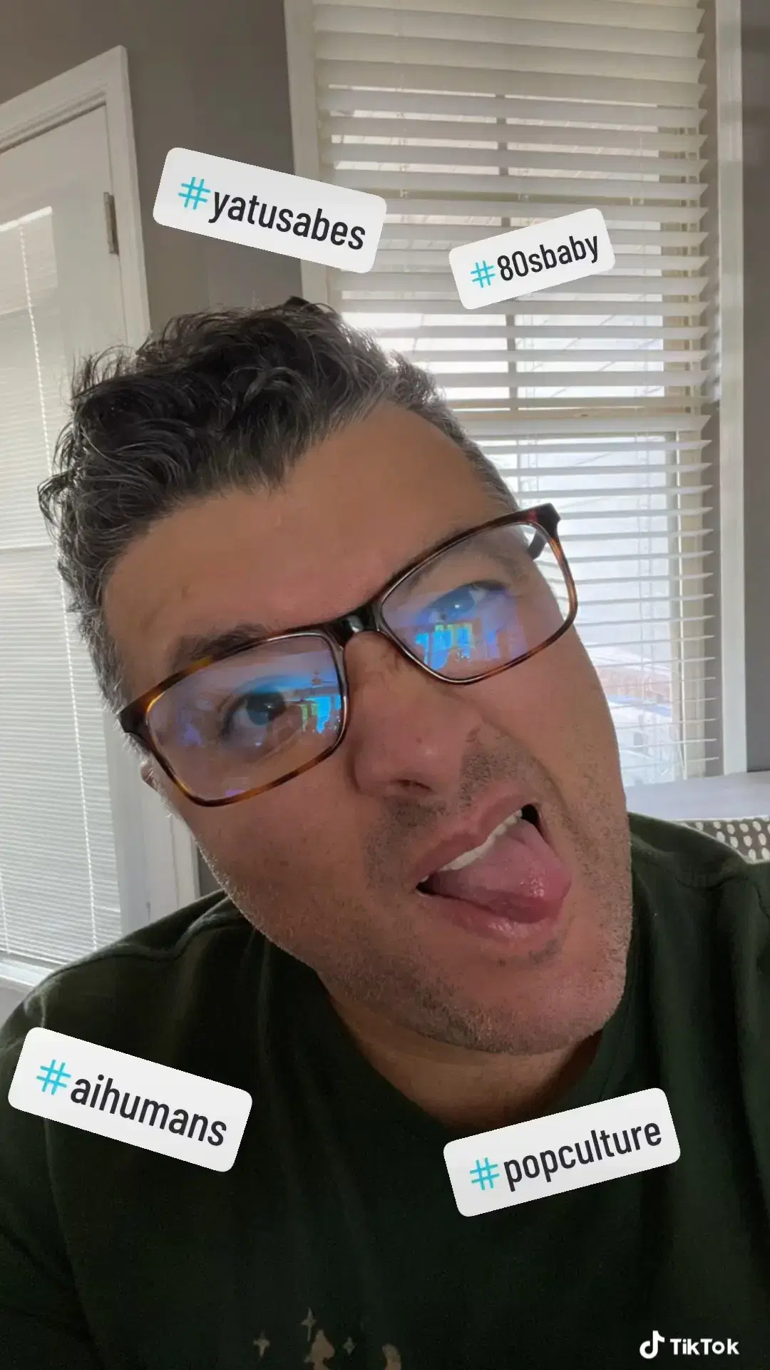 Andrei Olea making a funny face wearing a black t-shirt and glasses