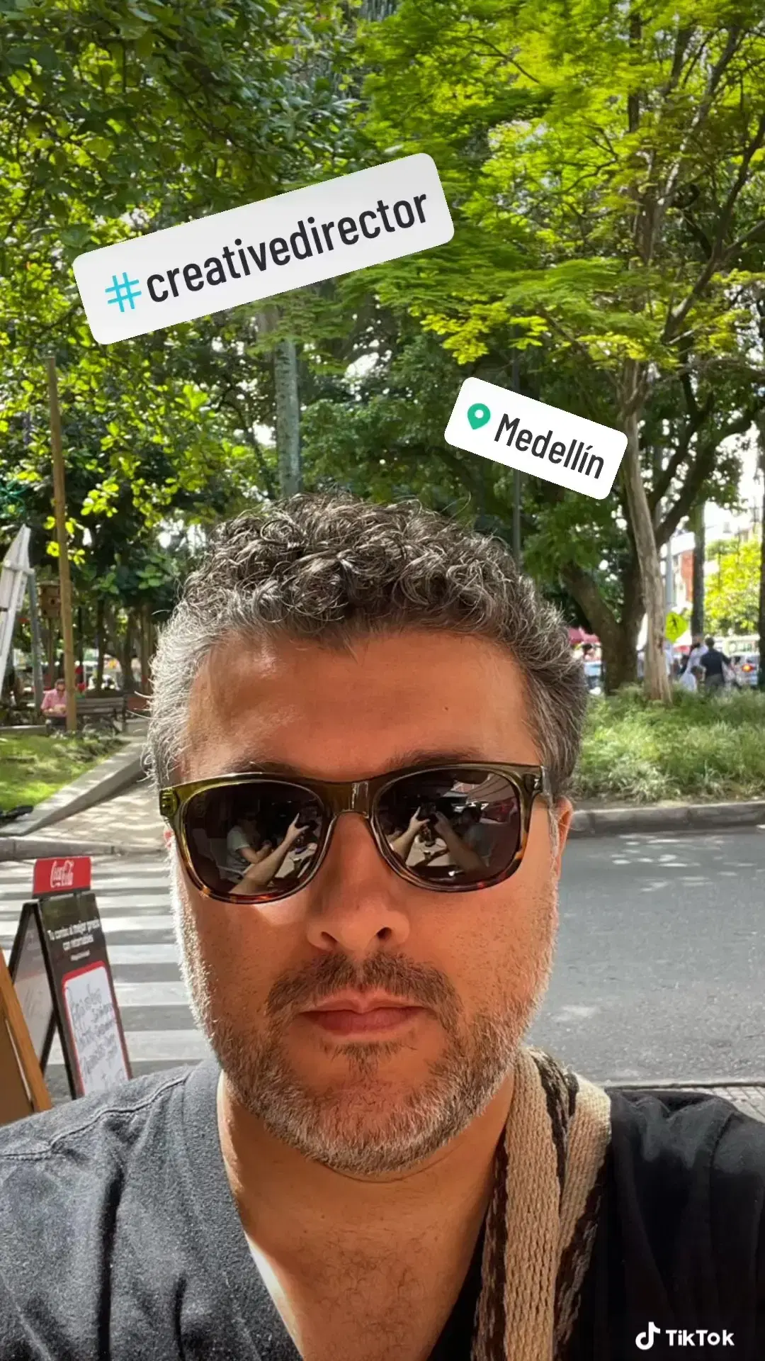 Andrei Olea in a casual setting wearing sunglasses and a black t-shirt